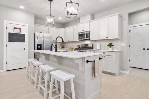 In the center of the kitchen, you'll see a large island with barstool seating.