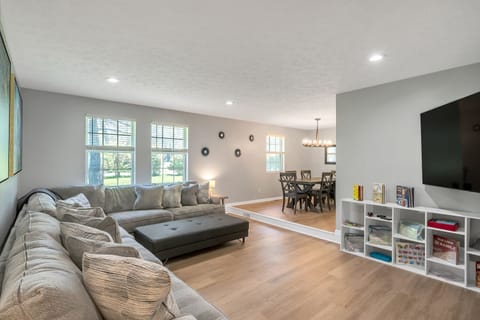 Large sunken living room with tons of space and seating! 75 inch TV