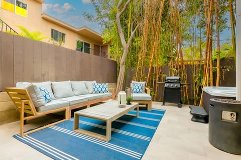 Private fenced patio with outdoor seating, gas grill and private hot tub
