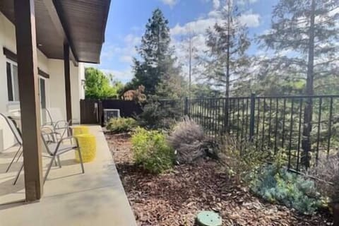 Exit master bedroom to a peaceful patio with four chairs and olive orchard views,ideal for relaxing.