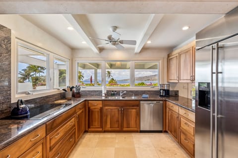 The kitchen is a chef's dream, recently refurbished with gorgeous Koa wood cabinets, granite countertops, stainless steel appliances