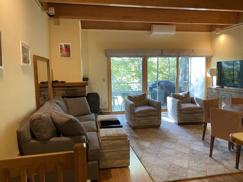 Open living/dining room has all new furniture, smart TV, opens to deck & grill.