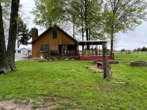Fire pit with benches and the front view of the house