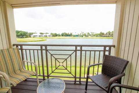 Covered balcony on second floor with 4 chairs & a small table!