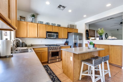 Stainless steel appliances, gas range, dishwasher and fully stocked for cooking.