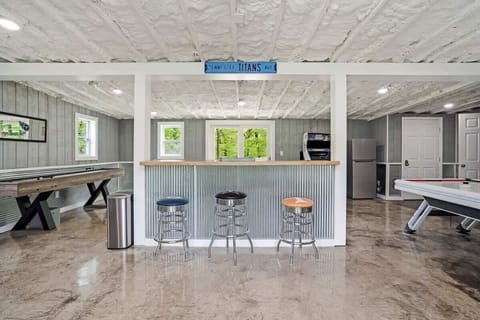 Game room featuring shuffleboard, air hockey, arcade, and darts. 