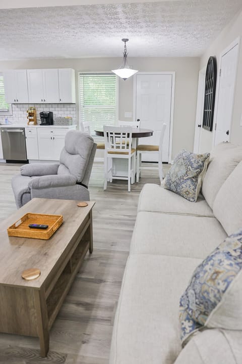 View from the living room into the kitchen with a round table and four chairs.