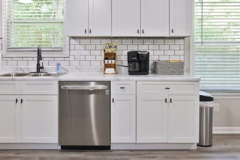 Keurig coffee pot with coffee and all the condiments and some snacks