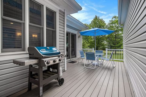 Back deck with gas grill and outdoor seating. 
