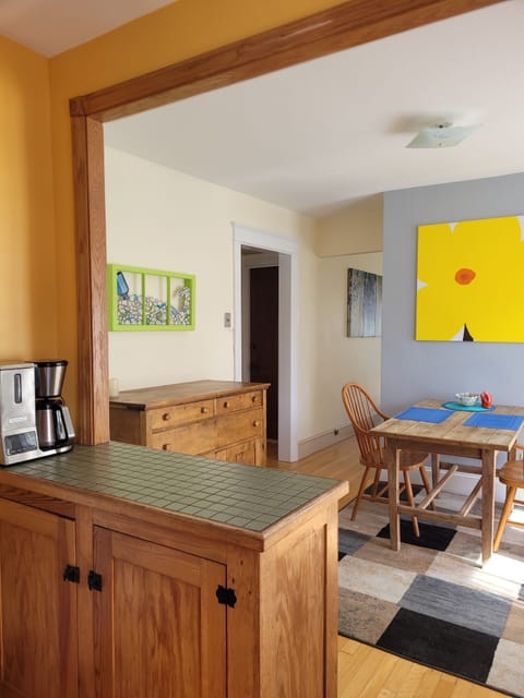 Cute as a button dining area with original art work and an Irish dining table. 