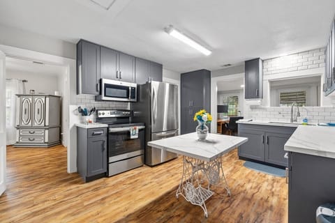 This home has a very functional kitchen with a ton cabinet space. The QUARTZ counter top is more spacious than expected for a home this size, There are stainless steel appliances. The accented subway tile and clean and functional space make it not only atheistically pleasing to guests but worth inviting guests over,