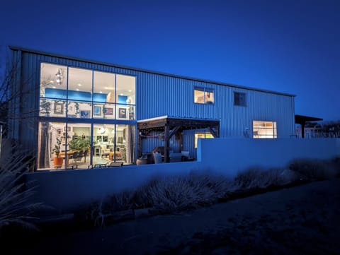 the back of the house at night -- main house is on the left