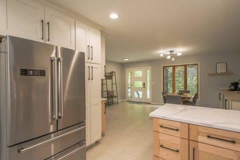 Stepping through the door, the fully stocked kitchen and beautifully designed dining table reveal themselves.