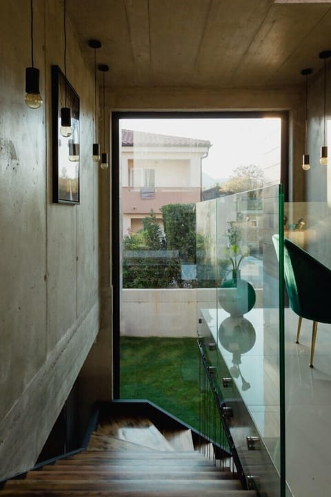Wooden internal stairs with a view of the courtyard and leading to the first floor of the luxury villa Krk Baska II on the island of Krk