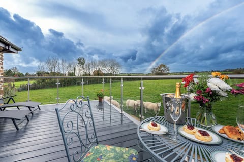 Enjoy dining out on the upper deck with views across the fields & sheep grazing