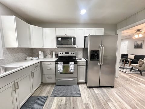 Fully equipped modern kitchen with stainless-steel appliances and sleek finishes.