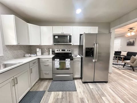 Fully equipped kitchen with stainless steel appliances, cookware, and coffee bar — ready for long-term stays.