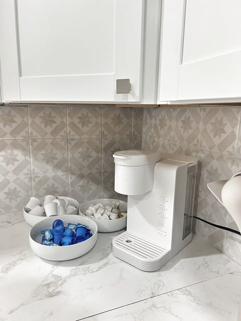 Start your mornings right at the stocked coffee bar — mugs, K-Cups, and more.