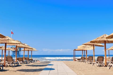 Stroll straight to the sand beneath breezy thatched umbrellas.