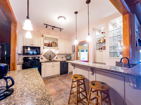 Full kitchen with refrigerator and ice maker on lower level.