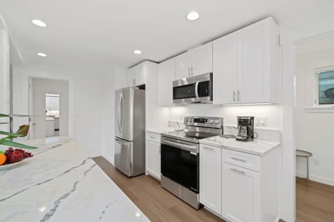 Open living space with living room with cable and streaming TV, electric fireplace, Dining table for 8, breakfast bar for 2 and Open to newly remodeled kitchen with all new appliances.