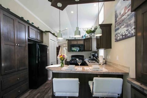 full kitchen with bar, gas stove and lots of storage