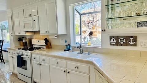 Kitchen features gas stovetop, microwave, oven, and Keurig
