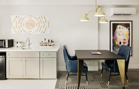 Sip morning coffee at the chic table under warm lighting.