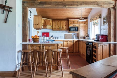 Well equipped farmhouse style pine kitchen with breakfast bar & seaview.
