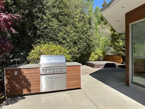 Step out to patio with outdoor barbecue, fire pit and soak in hot tub