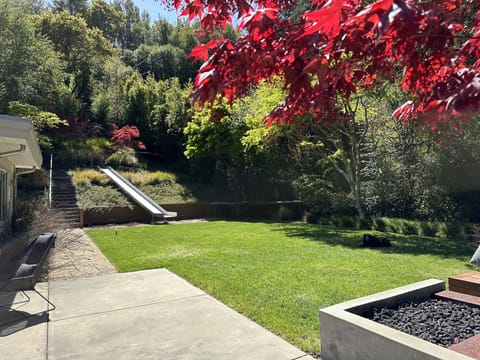 Private spacious back yard w/ fire pit, built in benches  & second seating area