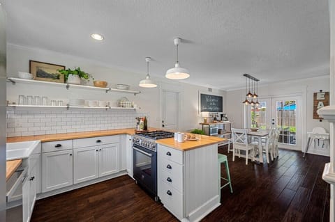Fully-Updated Kitchen with butcher block countertops and stainless steel appliances