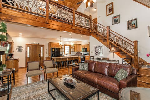 View of front entry, coffee bar, and kitchen from living room. Cabin has an airy feel to it yet exudes the warmth and coziness of a mountain cabin.