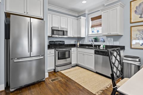 You'll love cooking in this bright, fully-equipped kitchen with stainless steel appliances and elegant white cabinetry.