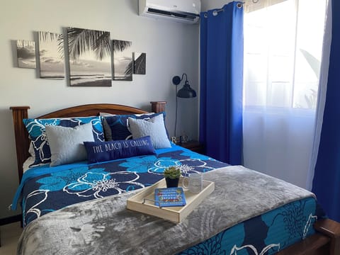 Adorable master bedroom with a queen size bed, smart TV,  A/C.