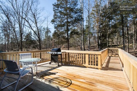 Private deck with grill and outdoor seating.
