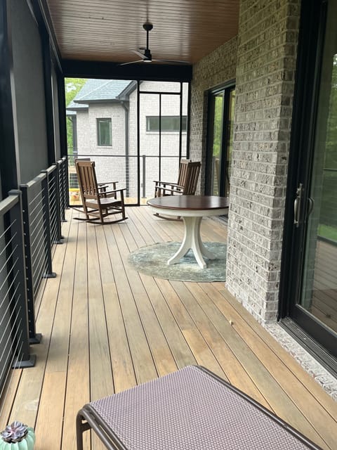 Screen porch extends the full length of the back of the Cottage. View from BR.