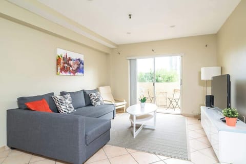 "Relax in this bright, modern living area! 🛋️ Featuring a cozy sectional and private balcony access, it’s the perfect home base for your next beach getaway or staycation. Enjoy comfort and style in this top-rated vacation rental. ✨"