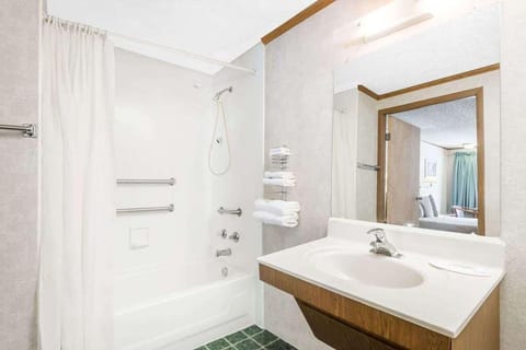Bathroom with a shower and tub. The essential toiletries and towels are provided