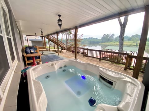 Covered terrace level with outdoor seating and hot tub