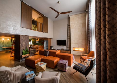 Unwind by the glowing fireplace in this soaring loft lounge.