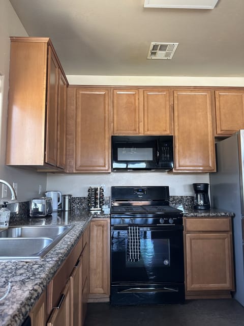 The large kitchen is equipped with what you need to cook a meal.