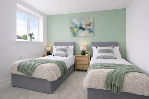 Bedroom 1 features a comfortable zip-link bed, configured as two single beds by default, or it can be zipped together to form a king-size bed upon request. Fresh linen and towels are provided for your stay.