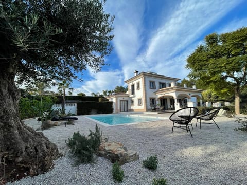 Picturesque view of the villa from the beautifully designed, landscaped gardens.