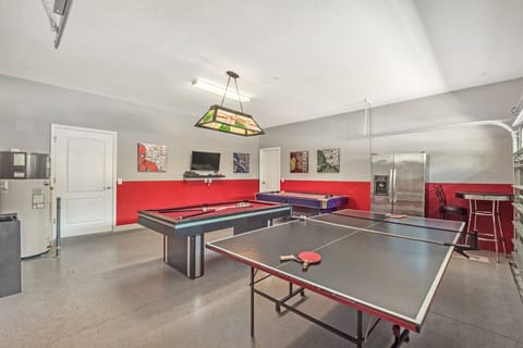 Game room garage with ping pong table and pool table