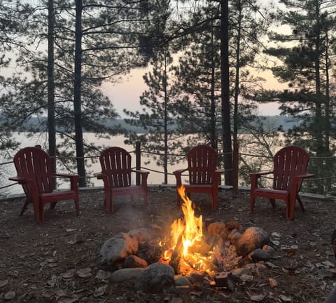 Gather under a painted sky at our lakeside fire pit, secluded, serene, and framed by towering pines.