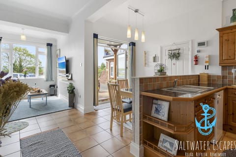 Fully equipped kitchen and dining area with table to seat 4 guests.