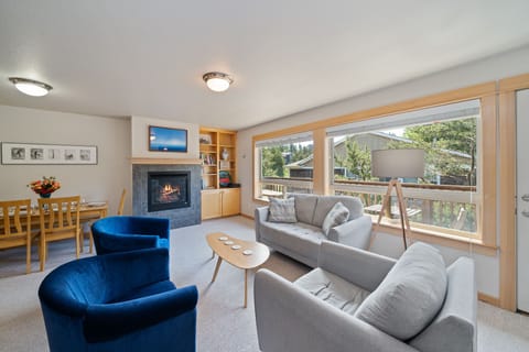 Living2 - Living area with books, games, gas fireplace, and access to upper deck area.