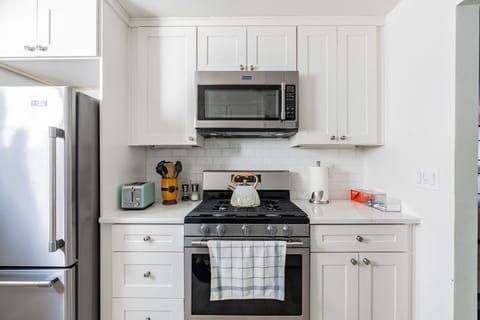 Full size kitchen with 5 burner gas stove and large size microwave 