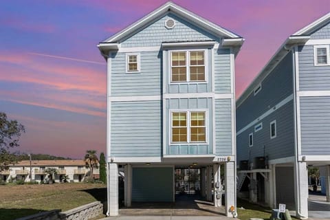 This charming stand-alone home features elevated coastal architecture and is situated in a prime location near the shore.